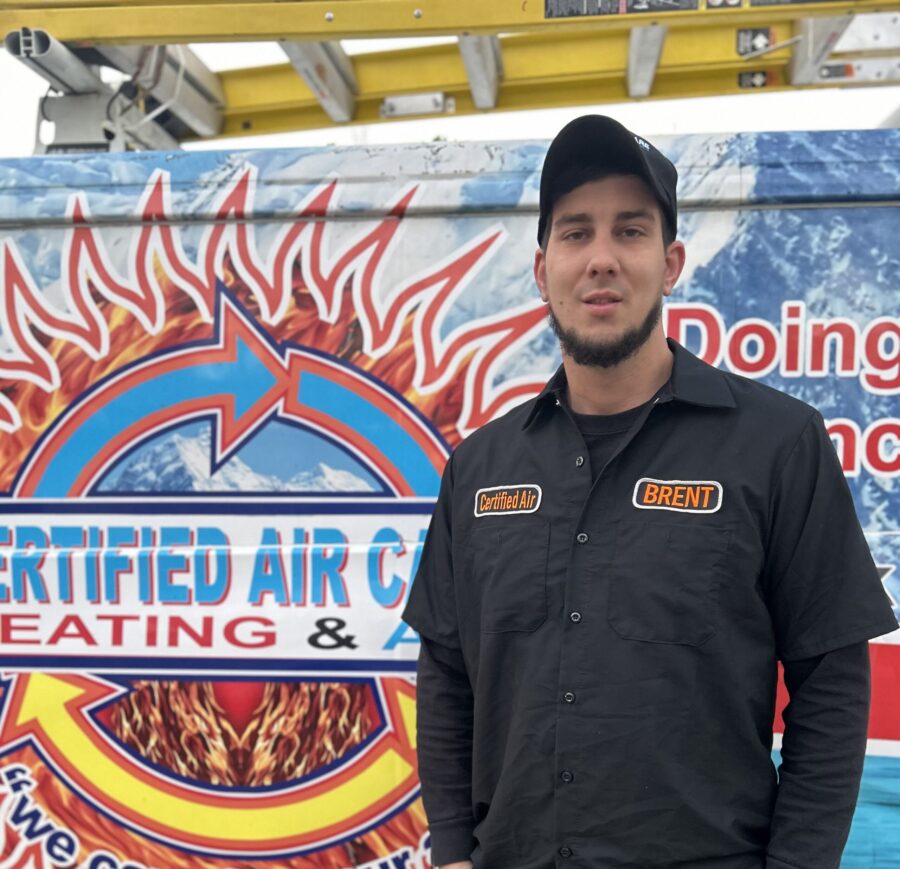 certified air care tech standing in front of van